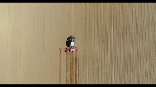 Aerial of Tractor on Harvest Field Ploughing Agricultural Field