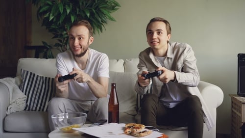Young Adults Playing Video Games at Home