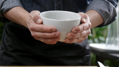 Chef Mixing Fresh Herbs in Bowl Outdoors