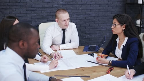 Team of Business People Discussing a Project in a Modern Office