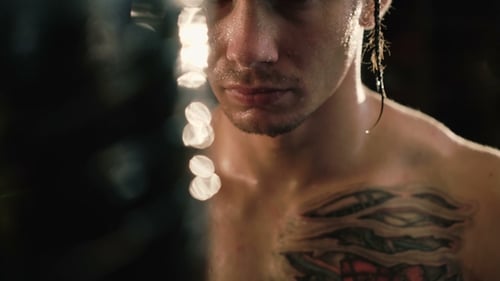 Sweaty Man with Cornrows and Tattoo