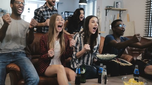 Friends Cheering and Celebrating on Brown Leather Couch