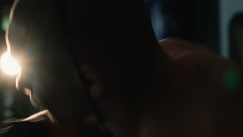 of Free Fighter Training Punching Bag in Dark Studio Slowly