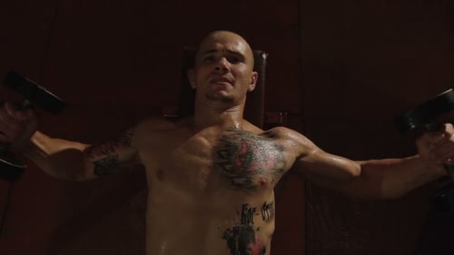 Muscular Man Lifts Dumbbells During Intense Workout