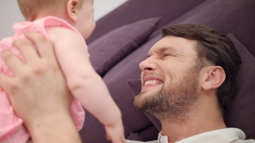 Loving Father Holds his Adorable Baby Daughter