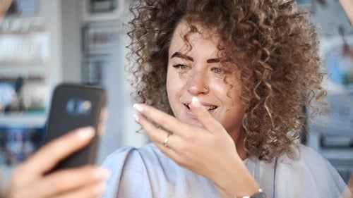 Attractive Woman with Curly Hair Taking Selfie