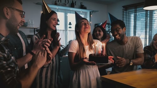 Friends Celebrate Birthday with Cake and Confetti