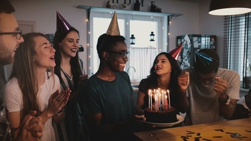 Friends Celebrate Birthday with Cake and Candles