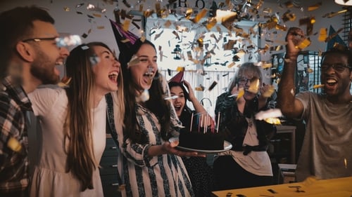 Friends Celebrate Birthday with Cake and Confetti
