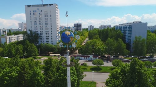 Aerial View of Urban Park with Globe Sculpture