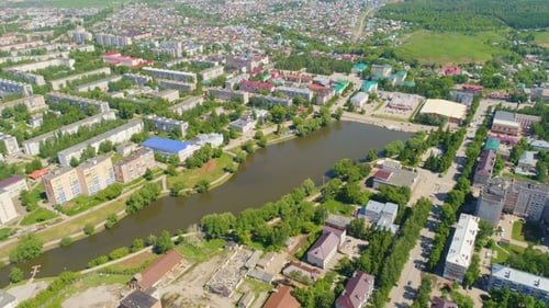Brown River Spreads Among Town with Buildings