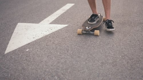 Skateboarder Pushing Off On Urban Road