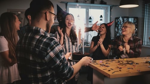 Friends Celebrate Birthday with Cake and Sparklers