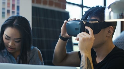 Man Using VR Headset in Modern Workplace