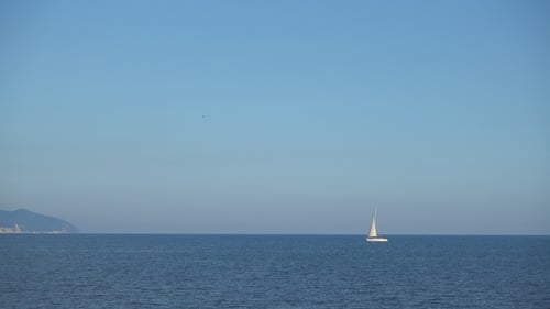 Beautiful Sailing Yacht Floats on Calm Sea Waves.