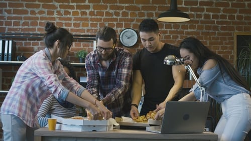 Colleagues in Office Eating Pizza Together