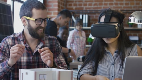 Diverse Colleagues Using VR While Constructing House
