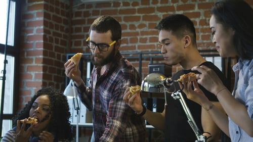 Colleagues in Office Eating Pizza Together