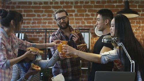 Colleagues in Office Eating Pizza Together