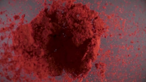 Vibrant Red Powder Explosion Filling the Frame