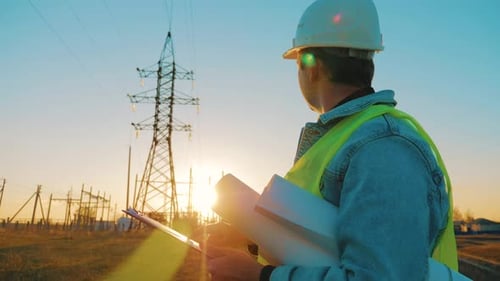 Architect Worker Checking Construction Project On Electric Tower
