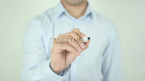 Man Writing Investment on Clear Surface