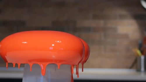 Rotating Bright Orange Cake with Dripping Glaze