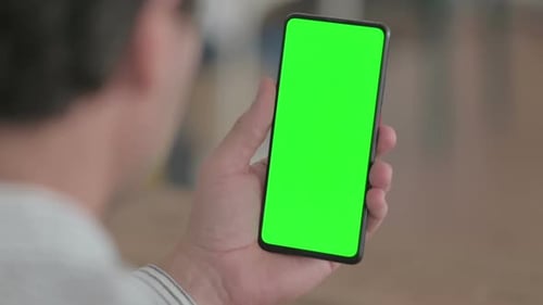 Smartphone with Green Screen Display Being Held