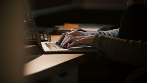 Woman Hands Using Laptop in the Dark