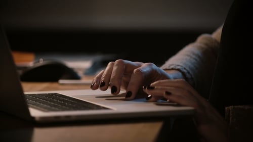 Woman's Hands Using Laptop Trackpad at Desk