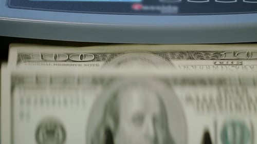 Money Counting Machine Processing US Dollar Bills