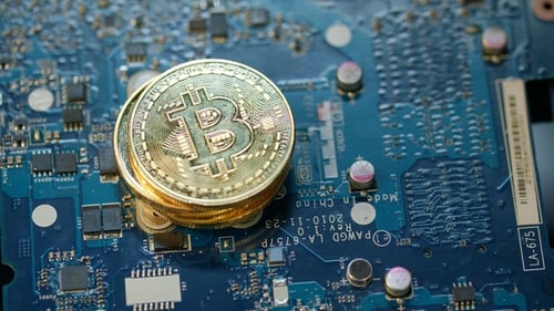 Modern Bitcoin Farm. Gold Bit Coin on Circuit Board