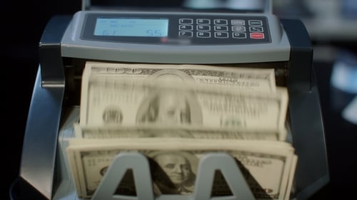 Money Counter Machine Counting Stacks of Dollar Bills