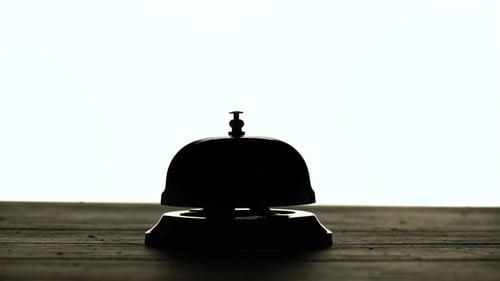 Hand Presses the Bell at the Reception
