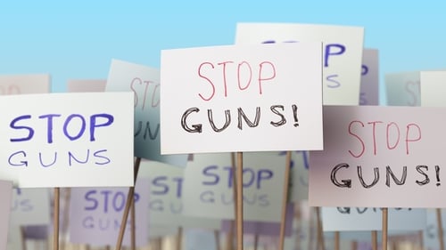 STOP GUNS Placards at Street Demonstration