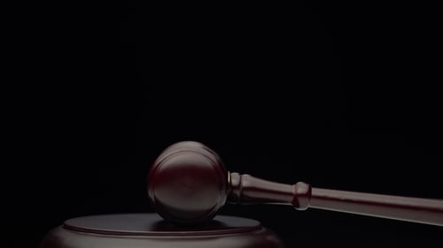 Wooden Judge's Hammer on the Stand Black Background