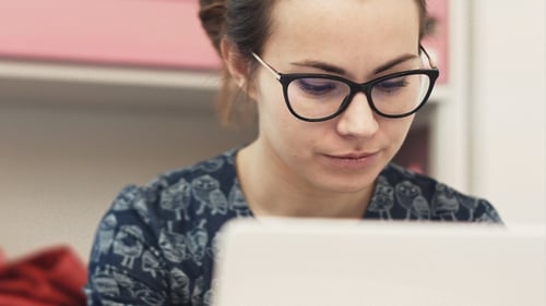 Woman with Glasses Using Laptop Computer Close-Up