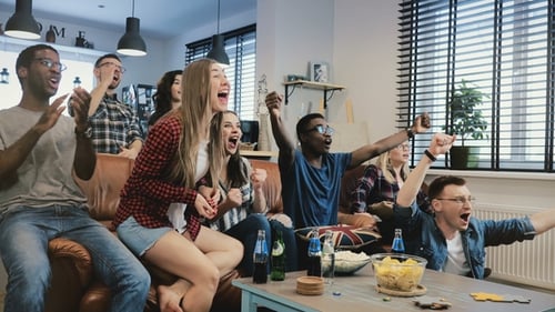 Enthusiastic Friends Watching Screen Together Indoors