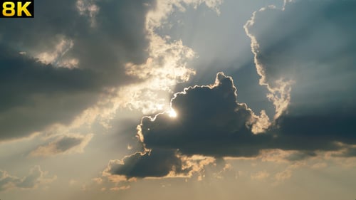 Dramatic Clouds Passing Bright Sun at Sunrise
