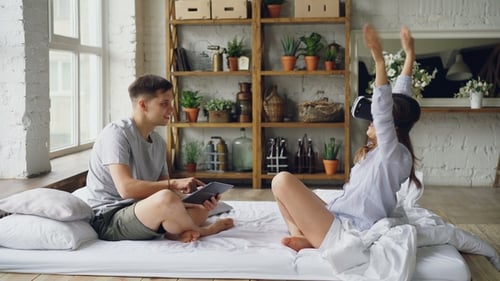 Young Couple Enjoying VR Technology in Sunny Home