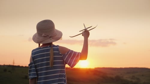 Child with Toy Airplane at Golden Sunset