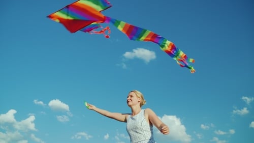 Woman Flying Kite On A Summer Day