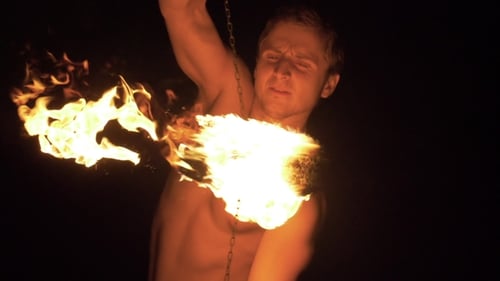 Man Spinning Burning Fire Poi at Night