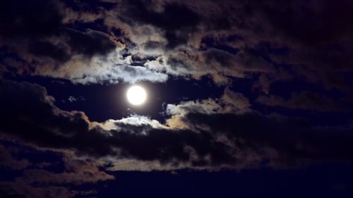 Dramatic Moon and Clouds in Night Sky