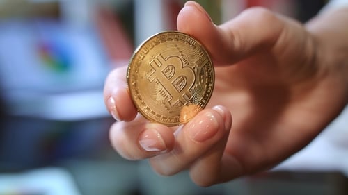 Hand Holding a Gold Bitcoin Cryptocurrency Coin