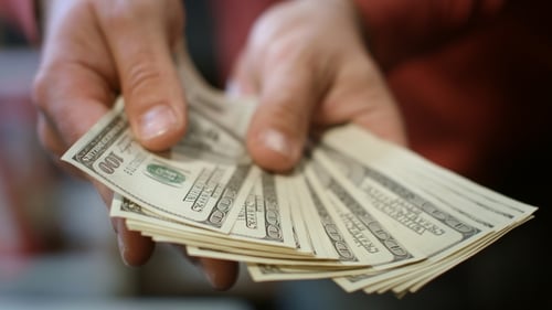 Stack of Hundred Dollar Bills in Hand