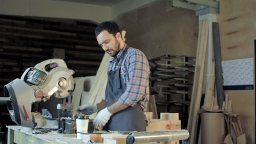 Carpenter Do Measurements on Wood Plank in Carpentry Workshop