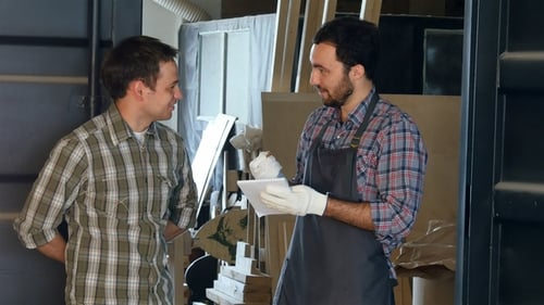 Two Carpenters Discussing Something in Workshop