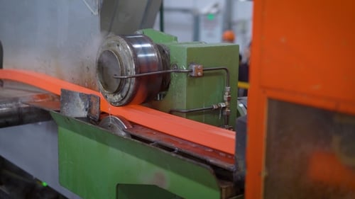 Metal Rod Moving Through Industrial Machine