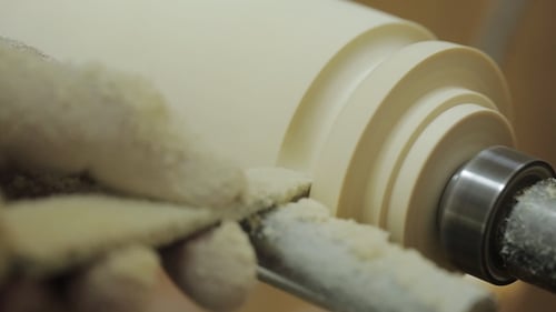 Turner Is Working on the Woodworking Lathe Machine with Chisel, a Lot of Wood Chips